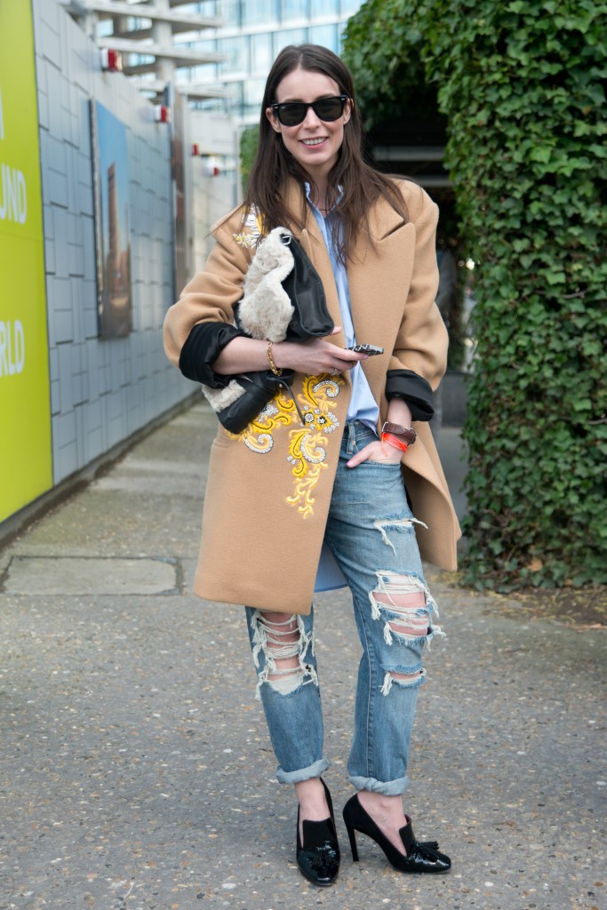 LONDON, ENGLAND - FEBRUARY 16: Fashion Blogger Irina Lakicevic wears Ray Ban sunglasses, Little Liffner bag, By Malene Birger shirt, Ralph Lauren jeans, Celine shoes, Dries Van Noten coat on day 3 of London Collections: Women on February 16, 2014 in London, England. (Photo by Kirstin Sinclair/Getty Images)