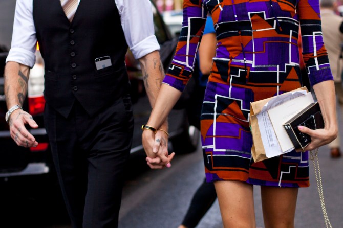 couple holding hands street style