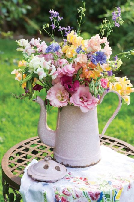 A watering can full of flowers