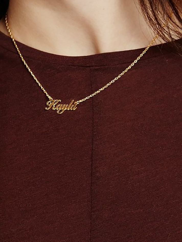 STYLECASTER | Word and Name Jewelry Is Having a Moment, Because Carrie Bradshaw Is a Forever Fashion Icon