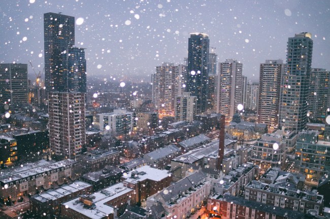 It's cold outside... but beautiful! Areal view of Toronto cityscapes on a magic winter blue hour with snowflakes dancing in the air.