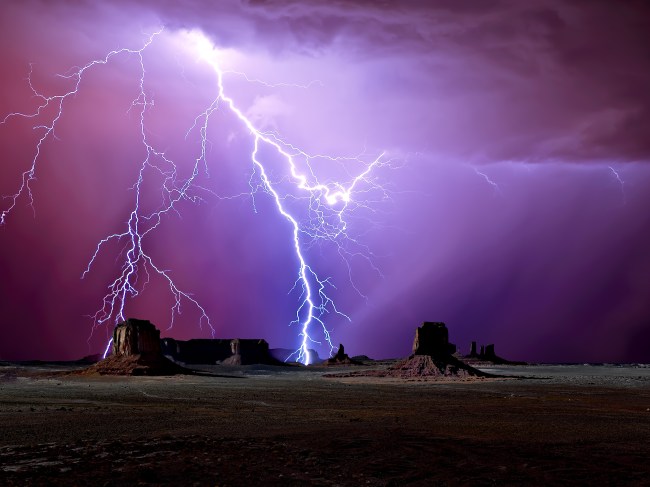 Lightning dancing in the sky over Arizona's Monument Valley. The colors and exposure effects were achieved with 32 Bit Color and HDR manipulation.