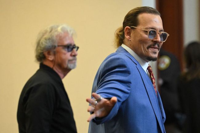 Johnny Depp gestures while departing the courtroom at the Fairfax County Circuit Courthouse in Fairfax, Virginia, on May 24, 2022. - Depp is suing ex-wife Amber Heard for libel after she wrote an op-ed piece in The Washington Post in 2018 referring to herself as a public figure representing domestic abuse.