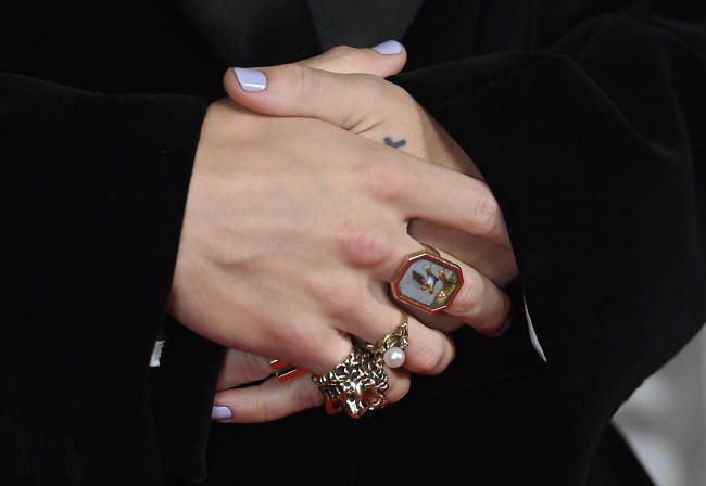 Harry Styles' hands covered in oversized mismatched rings