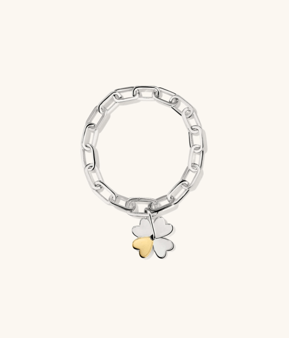 A silver link friendship bracelet with a silver and gold four-leaf clover charm