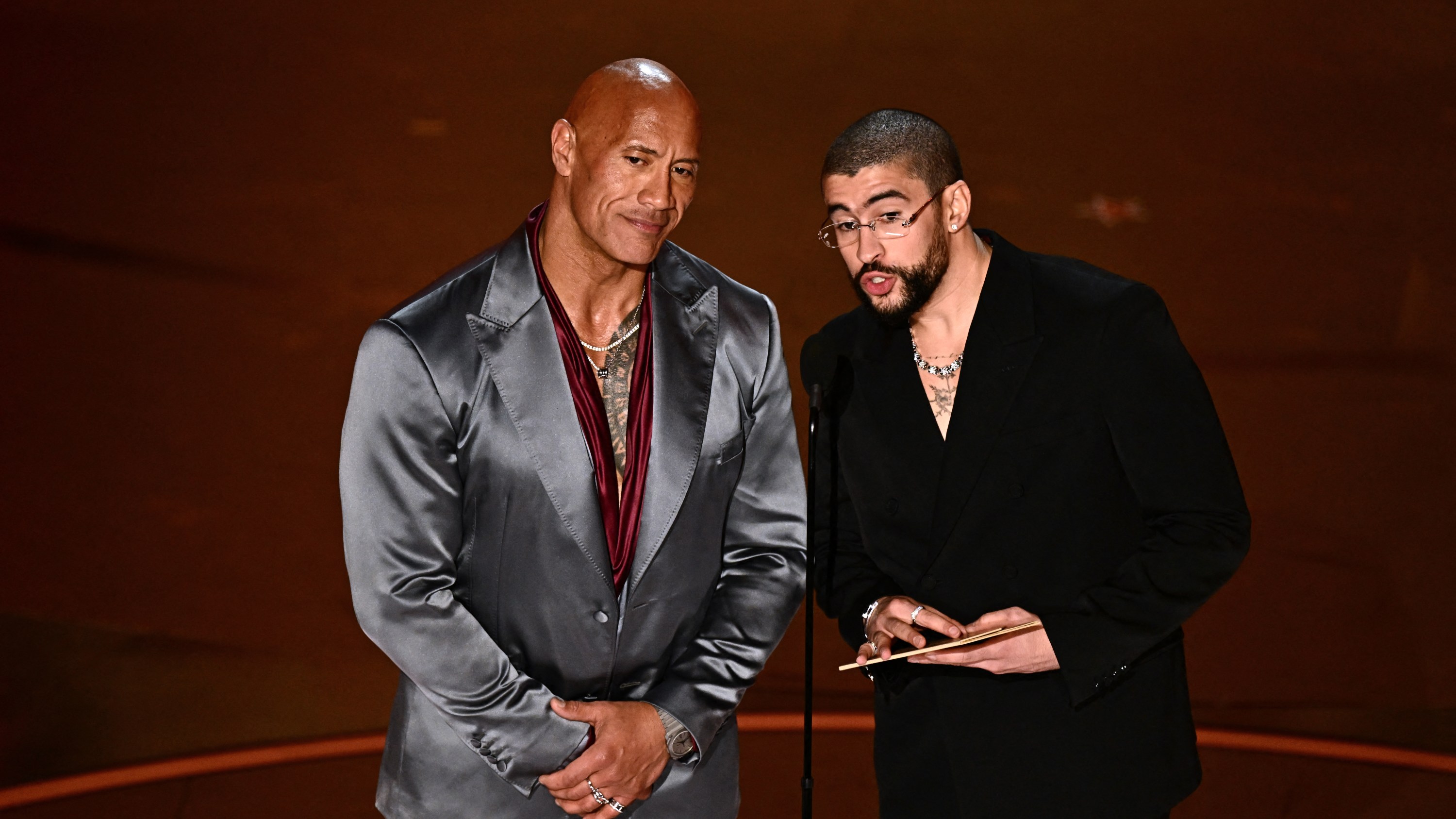US actor Dwayne Johnson (L) and Puerto Rican singer Bad Bunny present the award for Best International Feature Film onstage during the 96th Annual Academy Awards at the Dolby Theatre in Hollywood, California on March 10, 2024.