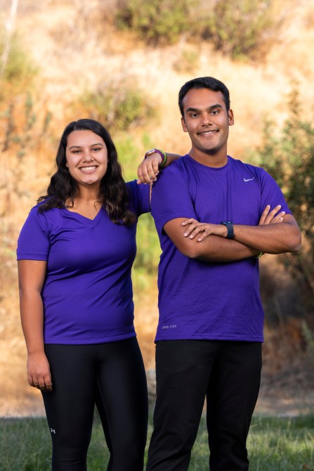 Maya, a south Asian woman with Rohan Rody, a south Asian man wearing matching violet athletic wear.