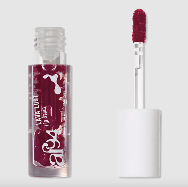 A deep berry colored lip stain that resembles a lava lamp in a clear bottle.