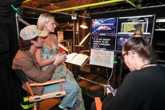 Chase Stokes and Kelsea Ballerini watch from backstage at the CMT Awards 2024