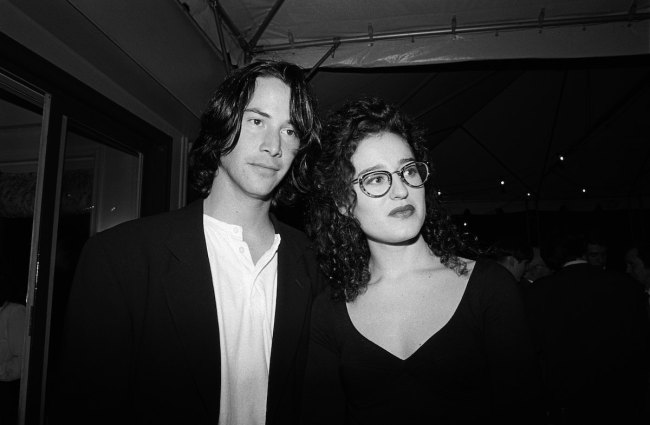 NEW YORK - MAY 1993:  Keanu Reeves, left, and MTV VJ Kennedy (aka Lisa Kennedy Montgomery) at a party for Kenneth Branagh's  film version of Shakespeare's "Much Ado About Nothing" in May 1993 in New York City, New York. Reeves starred in the film.