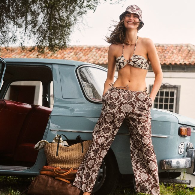 J.Crew. model is wearing a floral cutout halter bikini top