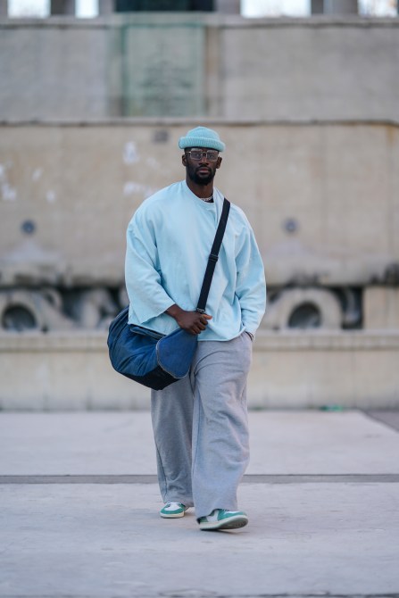 A fashion week guest wearing square silver Ray-Bans.