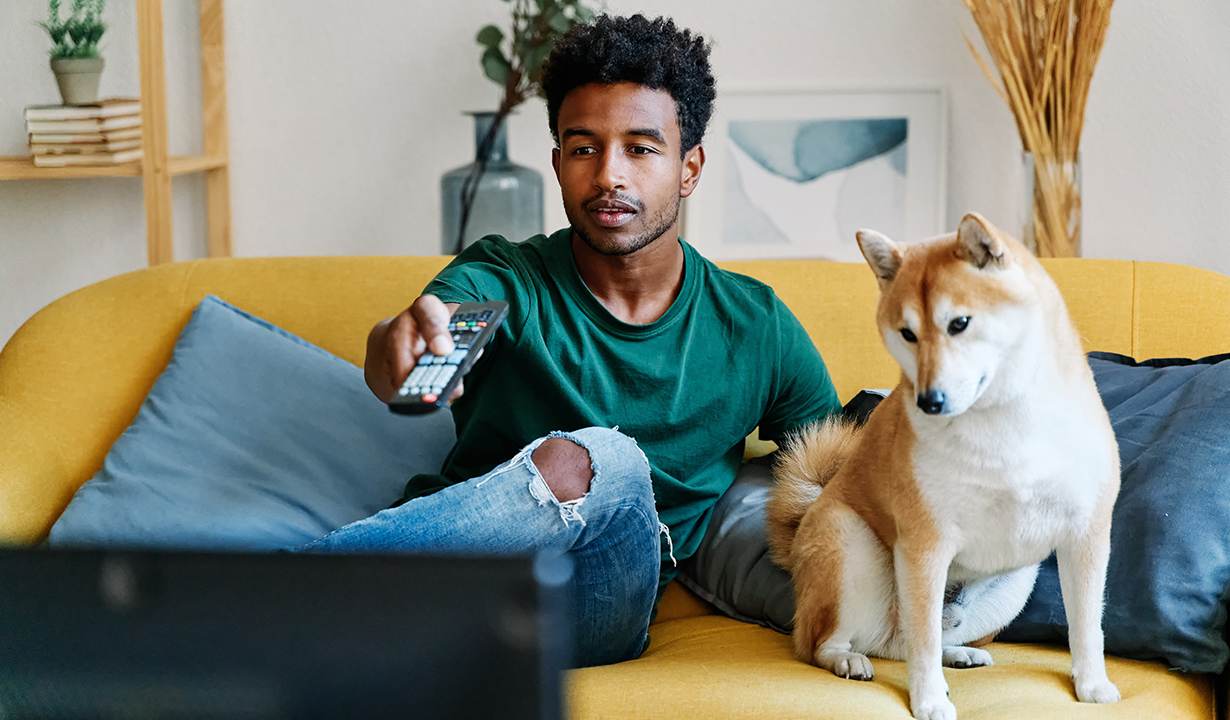 Man Watching TV With Dog