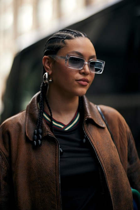 A fashion week guest wearing chunky hoops.