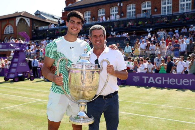 Carlos Alcaraz of Spain poses with the winner's trophy alongside father, Carlos Snr. after victory against Alex De Minaur of Australia in the Men's Singles Final match on Day Seven of the cinch Championships at The Queen's Club on June 25, 2023 in London, England.