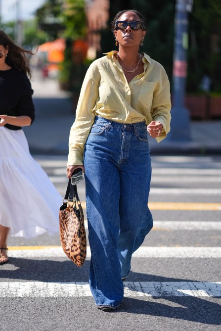 A woman carrying a leopard print bag at NYFW.