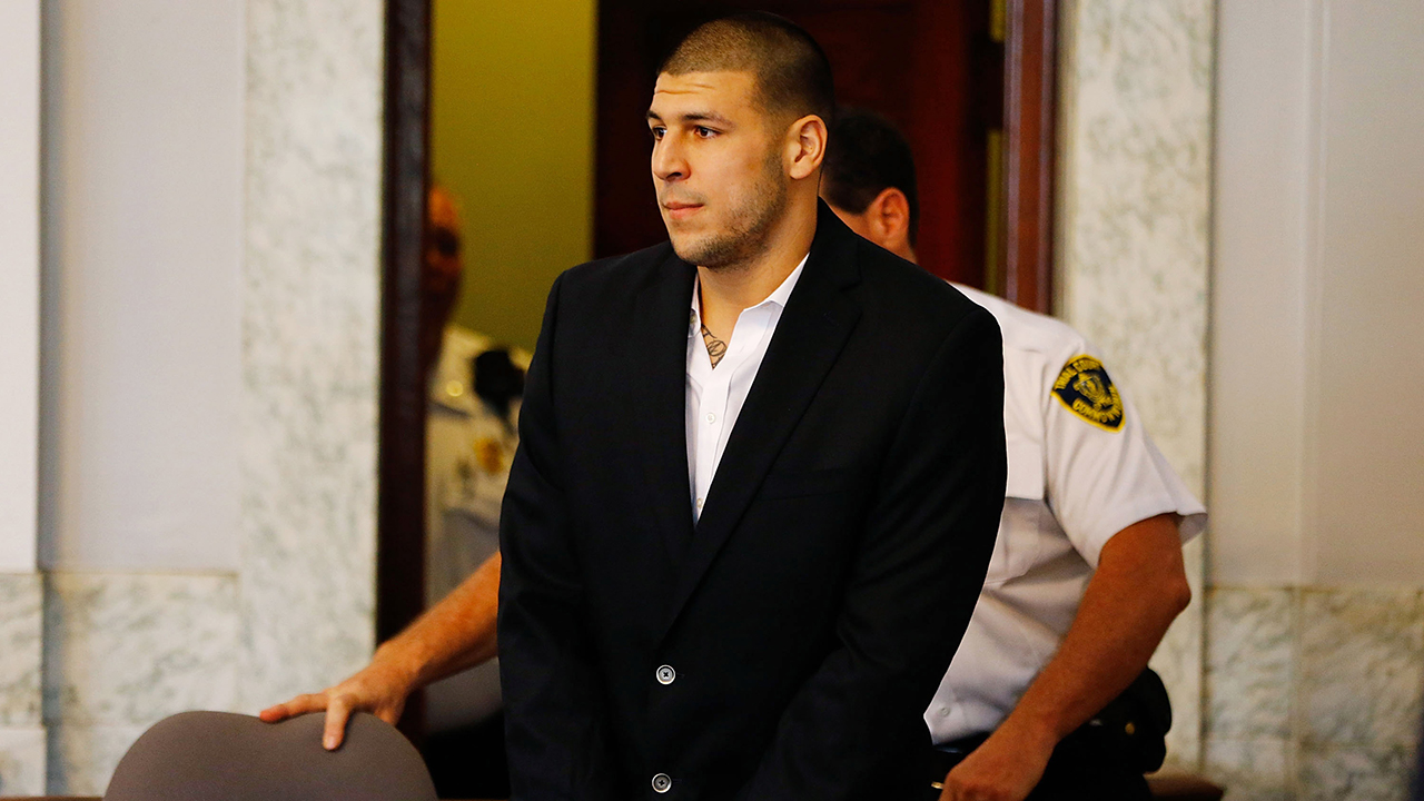 Aaron Hernandez is escorted into the courtroom of the Attleboro District Court for his hearing on August 22, 2013 in North Attleboro, Massachusetts. Former New England Patriot Aaron Hernandez has been indicted on a first-degree murder charge for the death of Odin Lloyd.