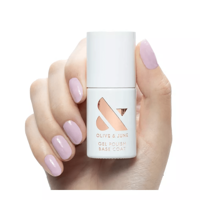 A hand model holding the Olive & June Gel Polish Base Coat