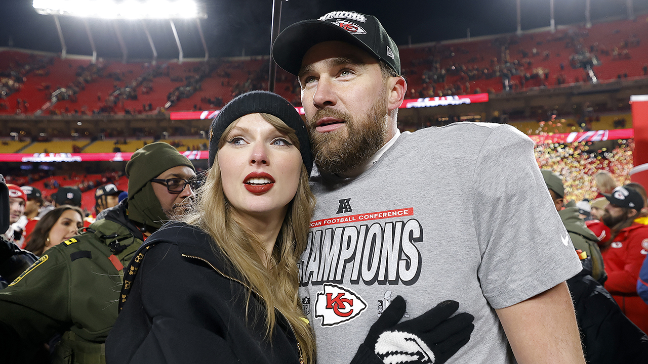 KANSAS CITY, MISSOURI - JANUARY 26: Taylor Swift celebrates with Travis Kelce #87 of the Kansas City Chiefs after defeating the Buffalo Bills 32-29 in the AFC Championship Game at GEHA Field at Arrowhead Stadium on January 26, 2025 in Kansas City, Missouri.