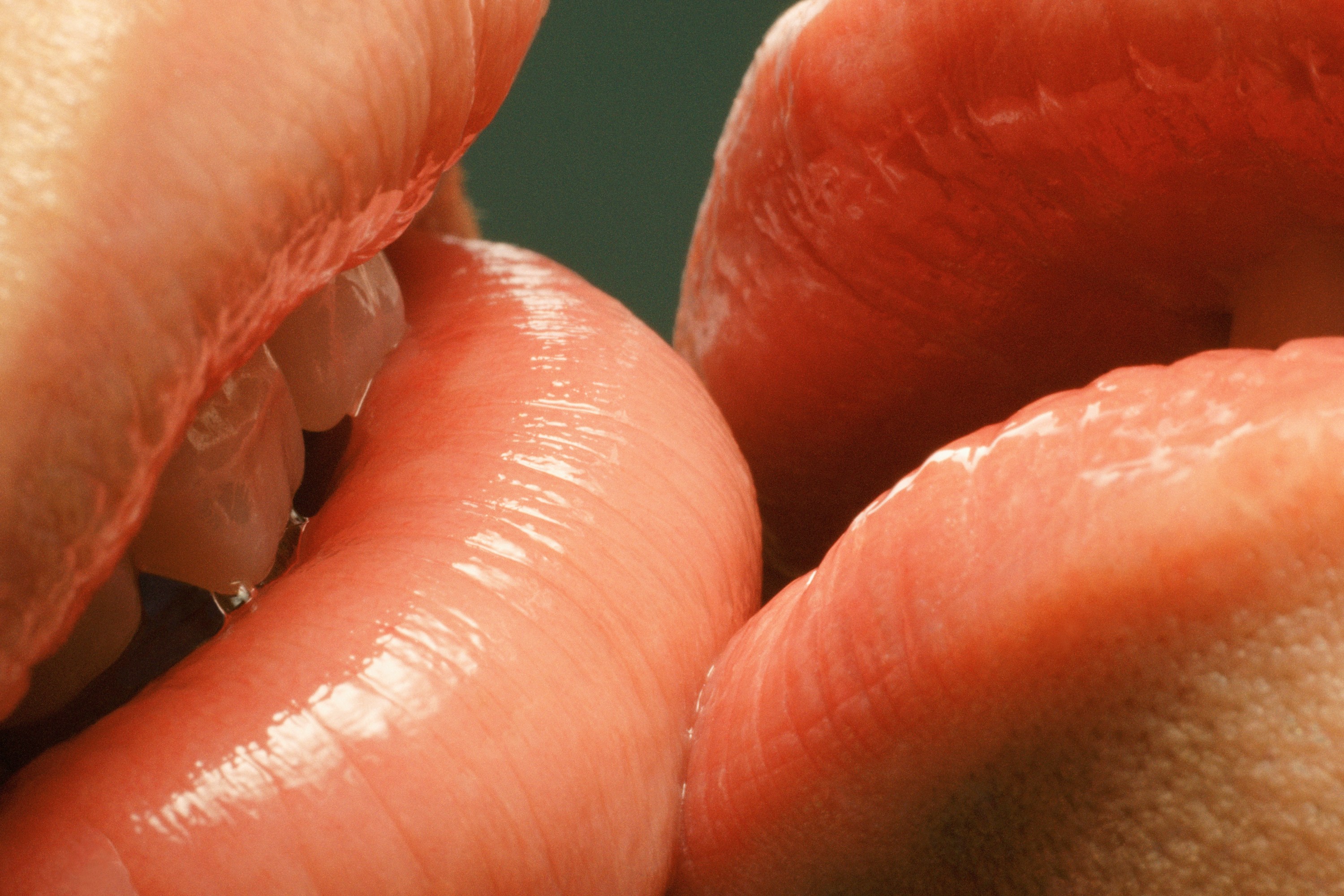 A close-up image of lips kissing