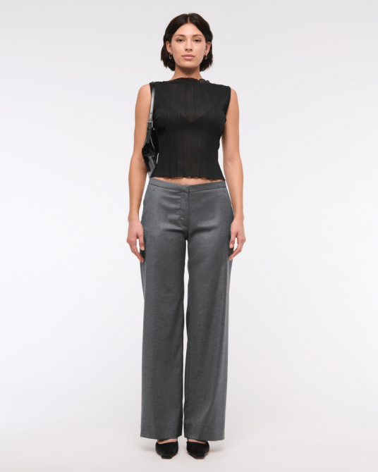 A model wearing the Abercrombie & Fitch Low Rise Clean Tailored Wide Leg Pant in gray