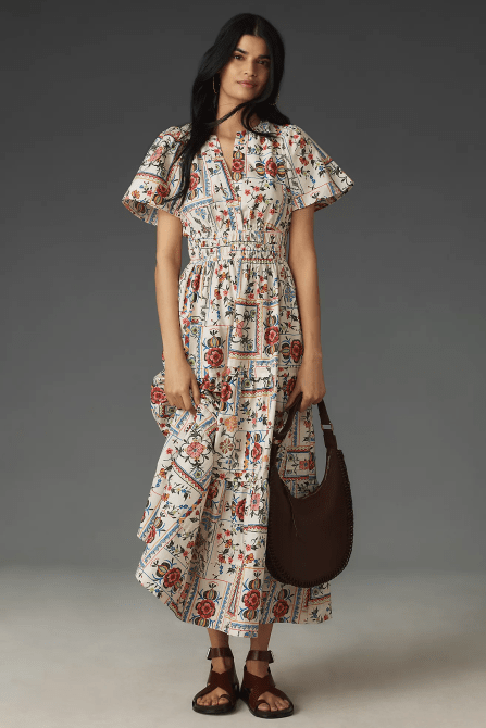 A model wearing the The Somerset Maxi Dress in a colorful ivory tile print